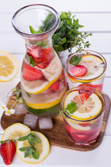 Fruit and herb infused water. Cold refreshing vitamin detox water. Summer drink