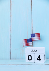 4th of july Wooden calendar and  american flags for memorial day or veteran's day background