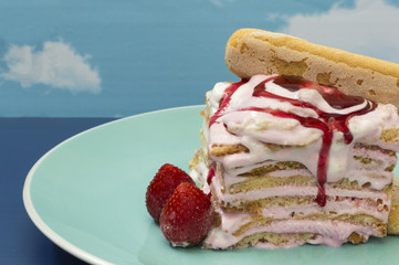 Strawberry iced cake on a blue background
