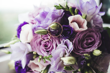 Wedding rings on perple flowers
