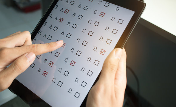 Student Testing In Online Exam In Form Exercise, Exams Answer On Tablet With Multiple-choice Quiz Or Questions By Finger Clicking
