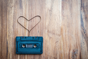 heart shape from cassette tape on vintage background, top view