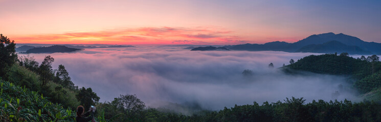 Landscape misty panorama. Fantastic dreamy sunrise on the mountains with a beautiful view. Foggy clouds above the landscape.
