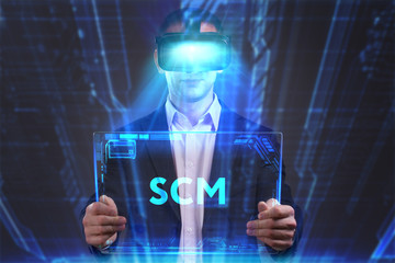 Business, Technology, Internet and network concept. Young businessman working in virtual reality glasses sees the inscription: SCM