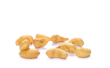 Unshelled roasted and salted cashew nuts isolated on white background
