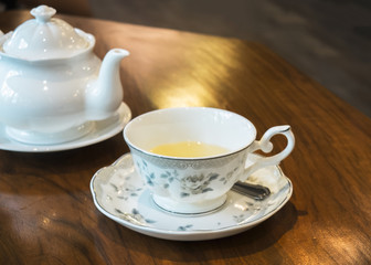 Antique Tea Set with White Jar and Beautiful Cup Full of Herbal Tea on Wooden Table for Tea Break Time or English Breakfast