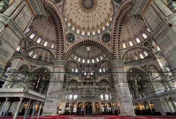 Fototapeta na wymiar Fatih Mosque, a public Ottoman mosque in the Fatih district of Istanbul, Turkey, with a huge decorated domes & many colored stained glass windows