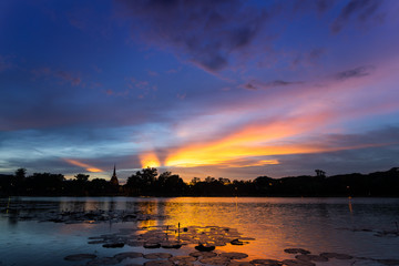 Silhouette Sunset / Sun Rise  Sky and reflection on water at Sukhothai Historical Park of Sukhothai city, Thailand