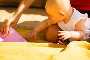 Little baby playing on beach during summertime
