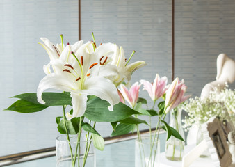 Bouquet of Big White Lilies in Glass Flowerpot at The Corner for Decoration in Wedding Ceremony