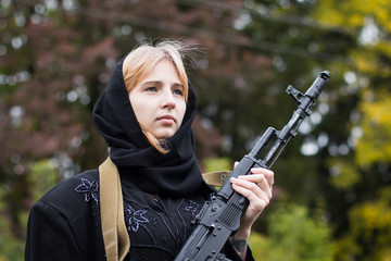 Girl with blond hair in black dress with arms