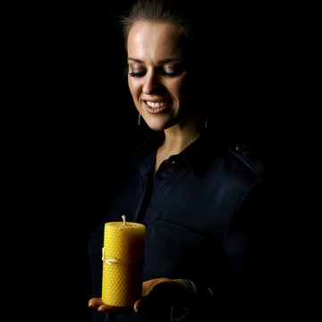 Smiling Woman Isolated On Black Background Looking At Candle