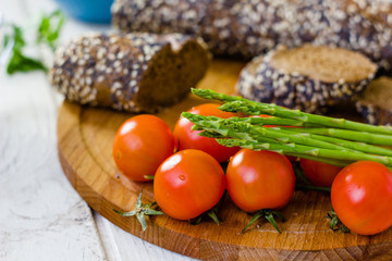 Fresh asparagus, bread and tomatoes