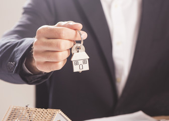 Real estate agent handing over house keys