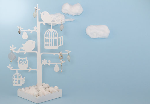 Baby boy blue background invitation with cottonwool clouds and bird trinket tree
