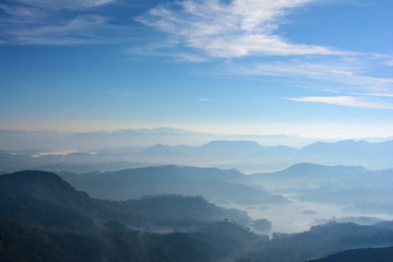 Fototapeta na wymiar Foggy mountains in the morning. View from the Adam's Peak, Sri Lanka
