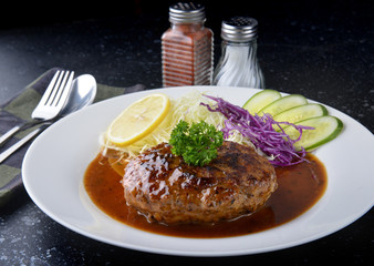Japanese style hamberger or hamberg serve with gravy sauce.
