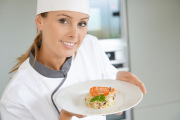 Cook chef presenting dish to camera