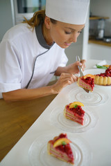 Professional pastry cook, cutting cake slices
