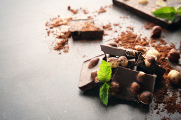 Broken chocolate pieces with mint on table