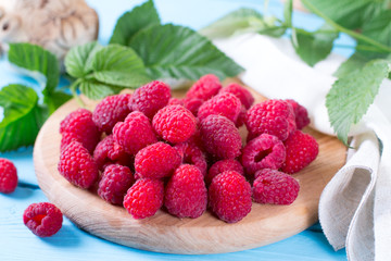 Fresh raspberries on a blue wooden background