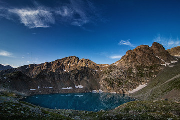 Naklejka na ściany i meble Alpine lake among the rocks