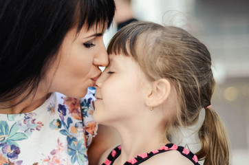 Daughter kissing mother