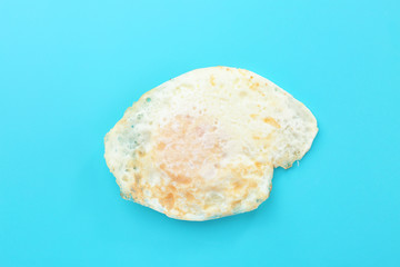 Delicious over hard egg on blue background