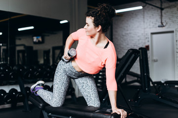 Fototapeta na wymiar Flexible young woman train in the gym