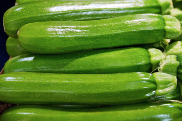 Green zucchini. Basket filled with whole green zucchini. Vegetable, raw food