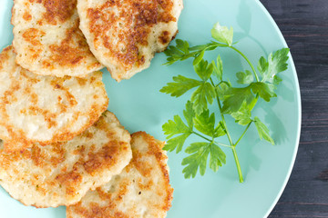 Draniki on a blue plate. Traditional Ukrainian and Russian cuisine.