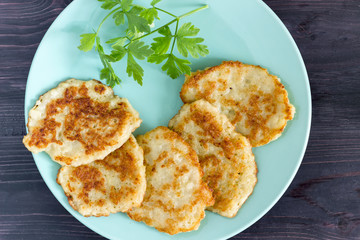 Draniki on a blue plate. Traditional Ukrainian and Russian cuisine.