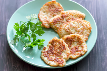 Draniki on a blue plate. Traditional Ukrainian and Russian cuisine.