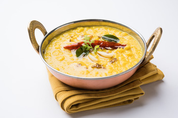 Indian popular food Dal fry or traditional Dal Tadka Curry served in a bowl, isolated over white or colourful background, selective focus - obrazy, fototapety, plakaty