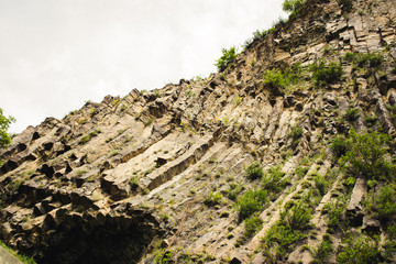 Mountain unique geological formation called Symphony of Stones. Basalt rock. Ecotourism. Nature background. Adventure holiday. Armenia, Garni. Travel vacation. Climbing tourism concept. Copy space