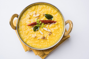 Indian popular food Dal fry or traditional Dal Tadka Curry served in a bowl, isolated over white or...