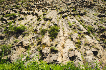 Mountain unique geological formation called Symphony of Stones. Basalt rock. Ecotourism. Nature background. Adventure holiday. Armenia, Garni. Travel vacation. Climbing tourism concept. Horizontal