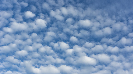 Blue sky with white clouds. Bright sky natural background.