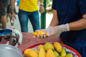 Chef is peeling mango