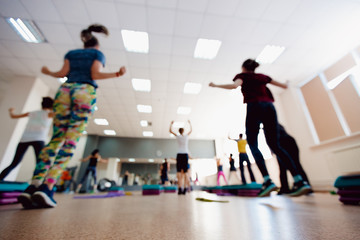 Fototapeta premium Blurred background of people group of girls playing in yoga and fitness,crossfit in the gym.