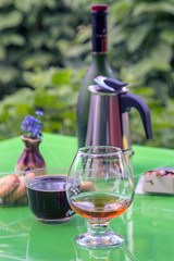 Glass of Cognac (brandy) on a green table