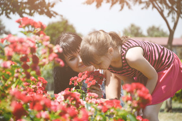 Mother and daughter in the flower garden