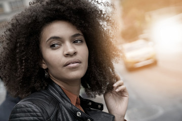 Ethnic girl waiting for taxi cab in New York city