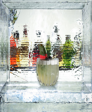 Tasty cocktail in the ice cube. Close up