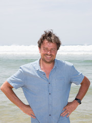 color portrait photo of a happy smiling man in his forties looking straight at camera