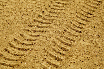 Fototapeta na wymiar Car tracks on sandy dune.