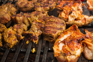 Pork steaks roast on a large grill