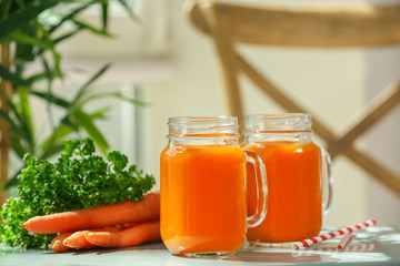 Mason jars of carrot juice  on table