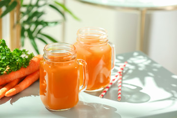 Jars of carrot juice  on table