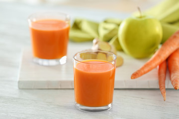 Glasses of carrot juice on light table